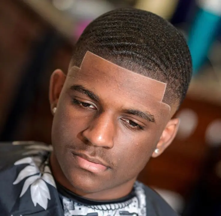 Sharp line-up and wave haircut by Wasafi Barbershop
